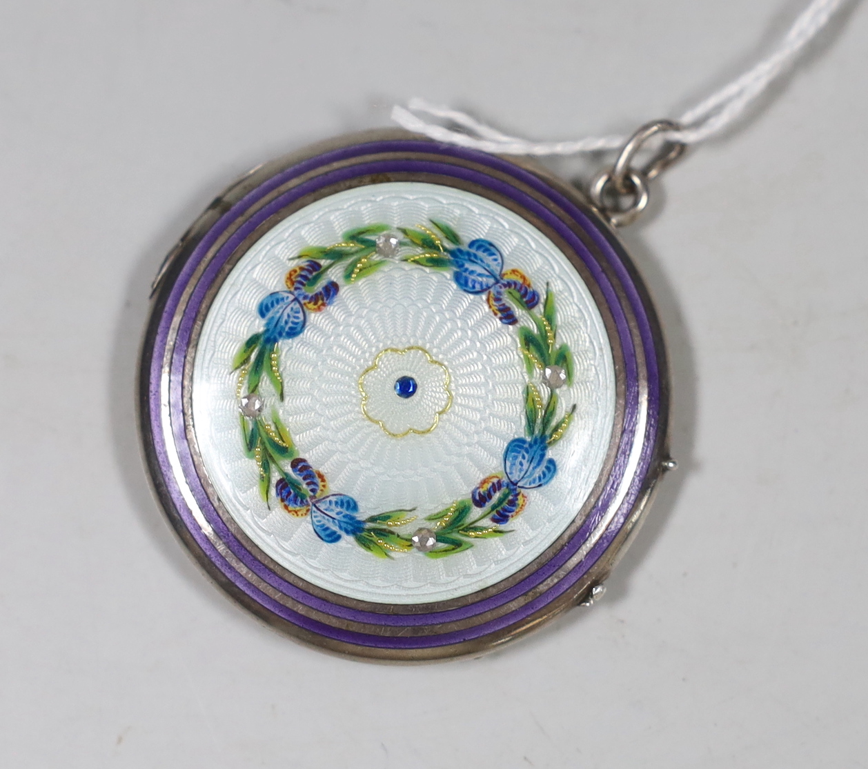 A mid 20th century white metal and polychrome enamel handbag compact, (lacking mirror?), 39mm.